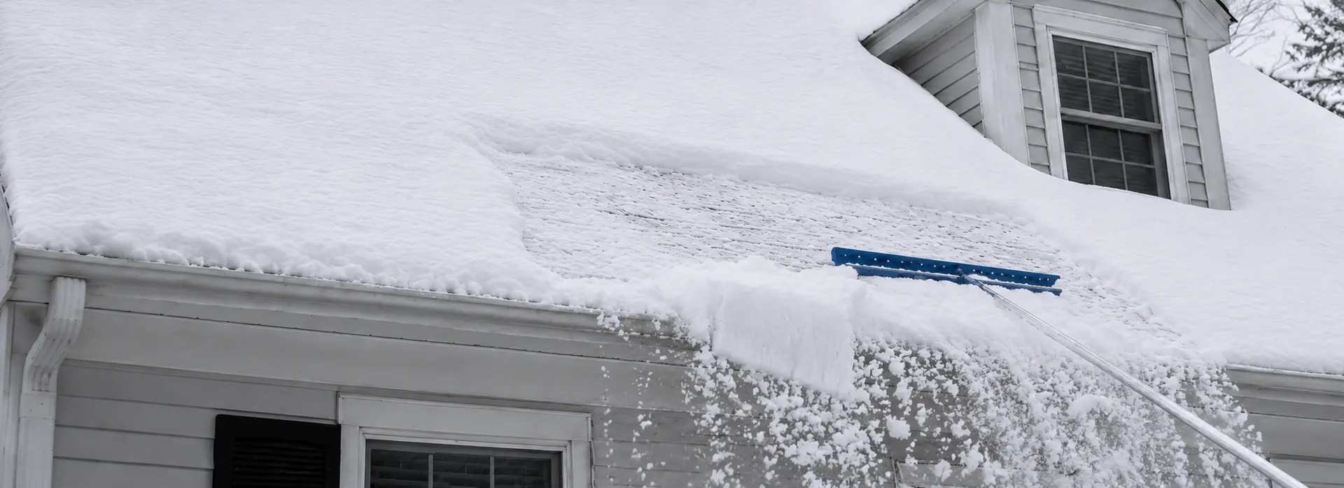 Roof raking to prevent ice dams on a New England home